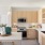 One-Bedroom Luxury Apartments in Wesley Chapel, FL - Aventon Meadows - Kitchen with Wood-Inspired Flooring, Stainless Steel Appliances, Beige Elm Cabinets, Quartz Countertops, Hexagon Tile Backsplash, and Kitchen Island with Accent Pendant Lighting.